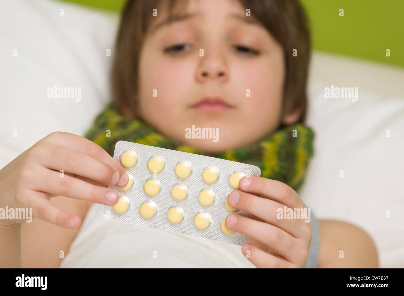 sick boy takes tablets Stock Photo