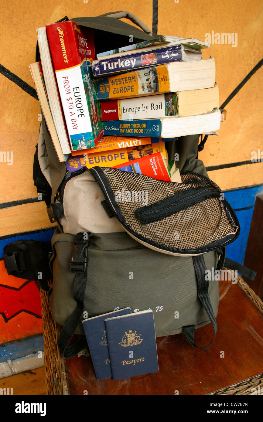 Travel books spilling out of a well traveled Backpack. Stock Photo