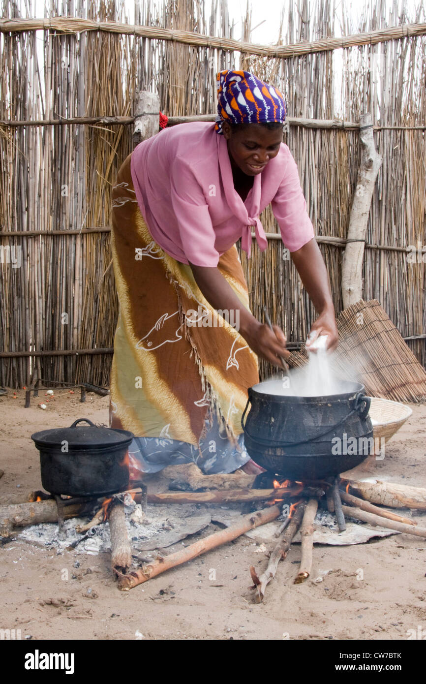 native woman preparing the food in a traditional way, Namibia, Mahango National Park Stock Photo