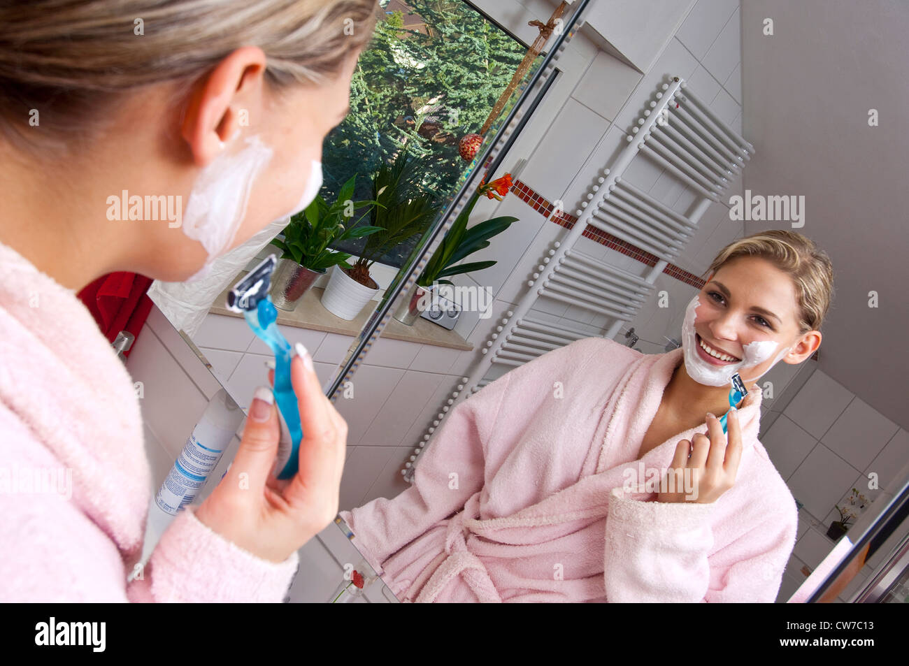 young woman shaving her facial hair Stock Photo Alamy