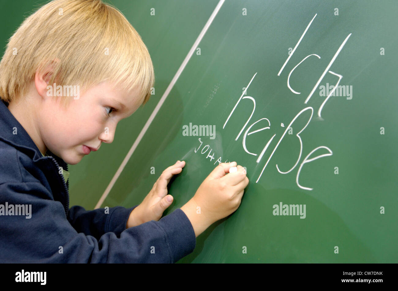 Boy writes his name on the blackboard Stock Photo Alamy