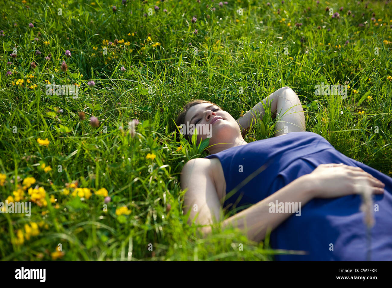young girl lying in the grass relaxed Stock Photo Alamy