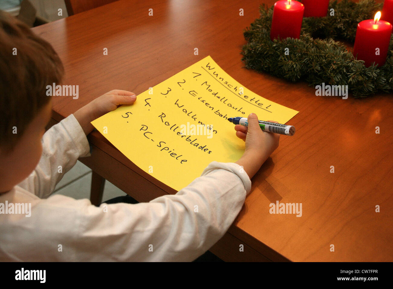child writes list of wishes Stock Photo