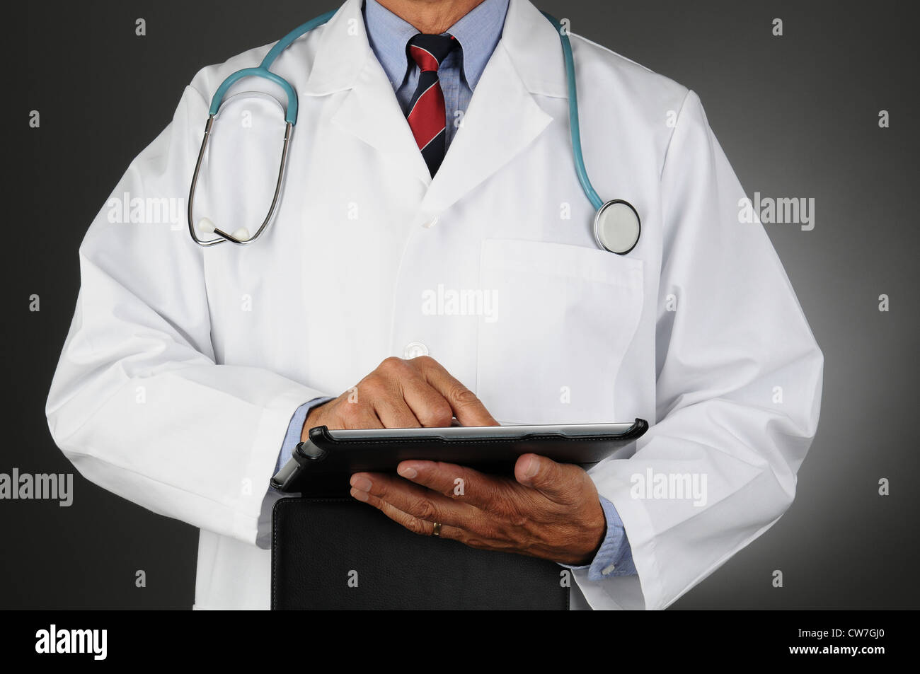 Closeup of a doctor using a tablet computer. Horizontal format over a ...