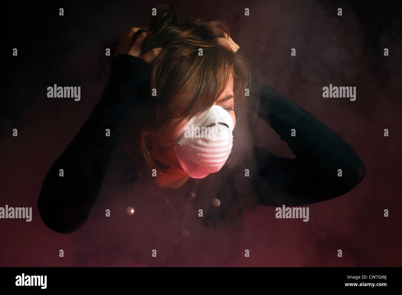 Woman in medical mask inside clouds of smoke Stock Photo