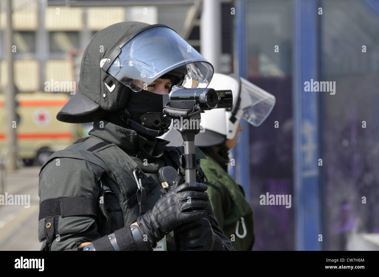 policeman shooting police operation at NPD deployment with video camera, Germany, Baden-Wuerttemberg Stock Photo