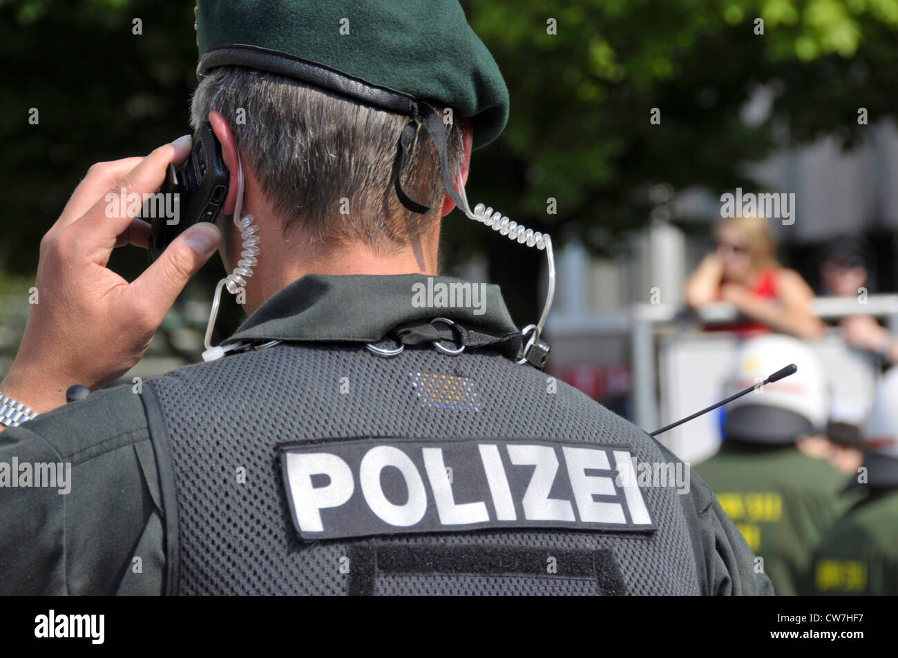 policeman of arrest unit with cell phone, Germany, Baden-Wuerttemberg Stock Photo