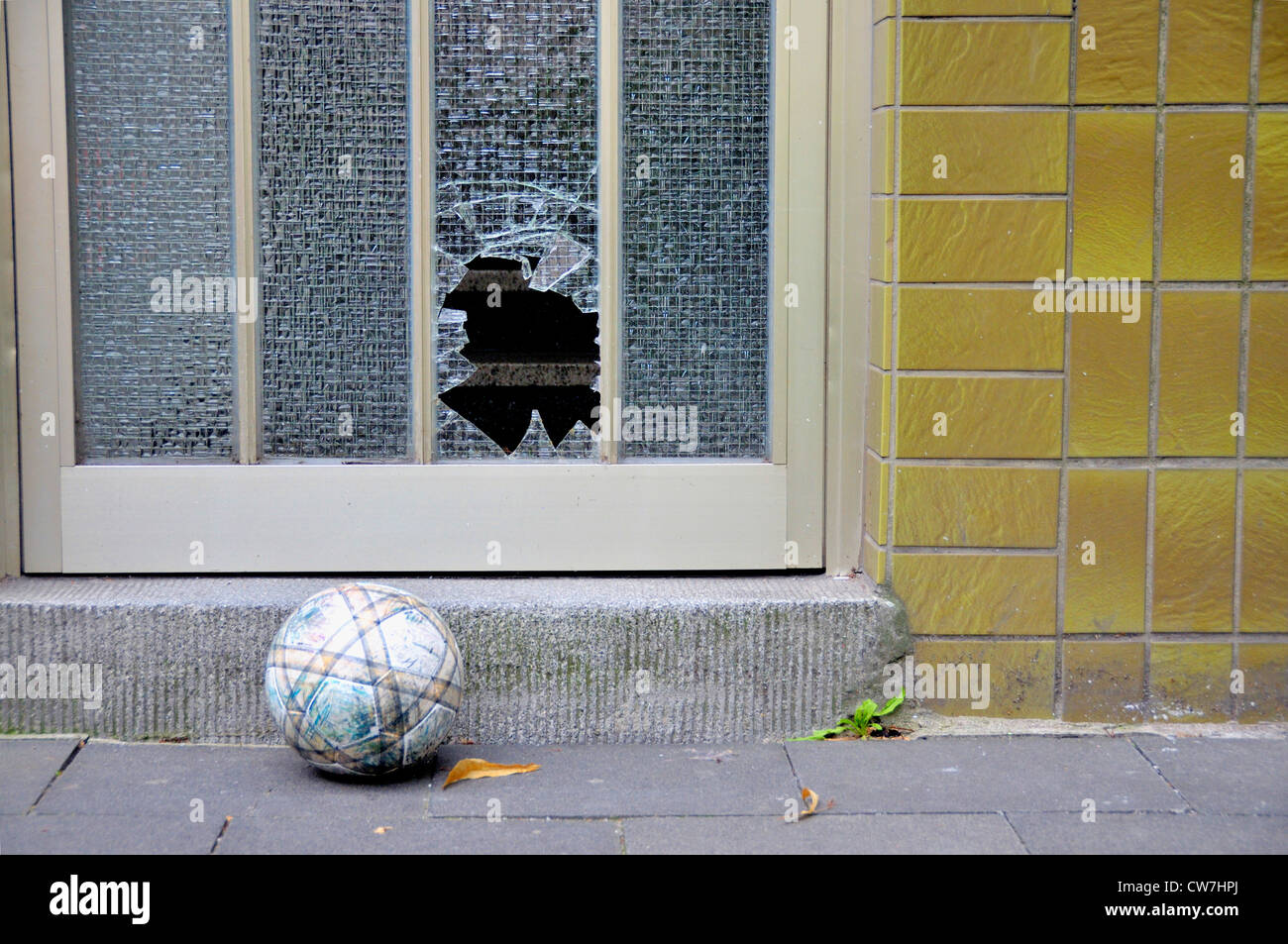 broken glass panel with football, Germany Stock Photo
