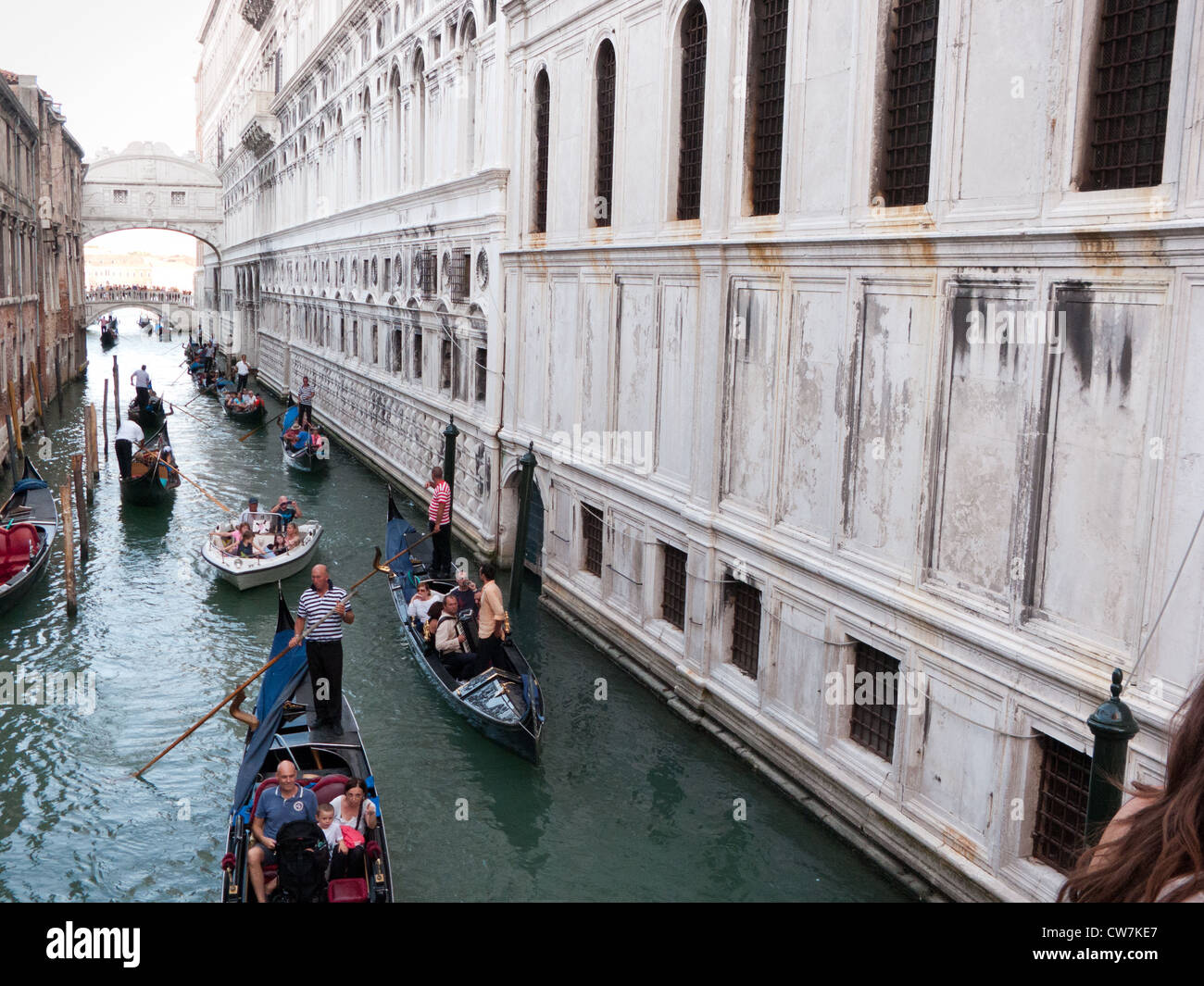 Tourists soak up the atmosphere of the Rio del Palazzo with the bridge of Sighs in the distance Venice, Italy Stock Photo