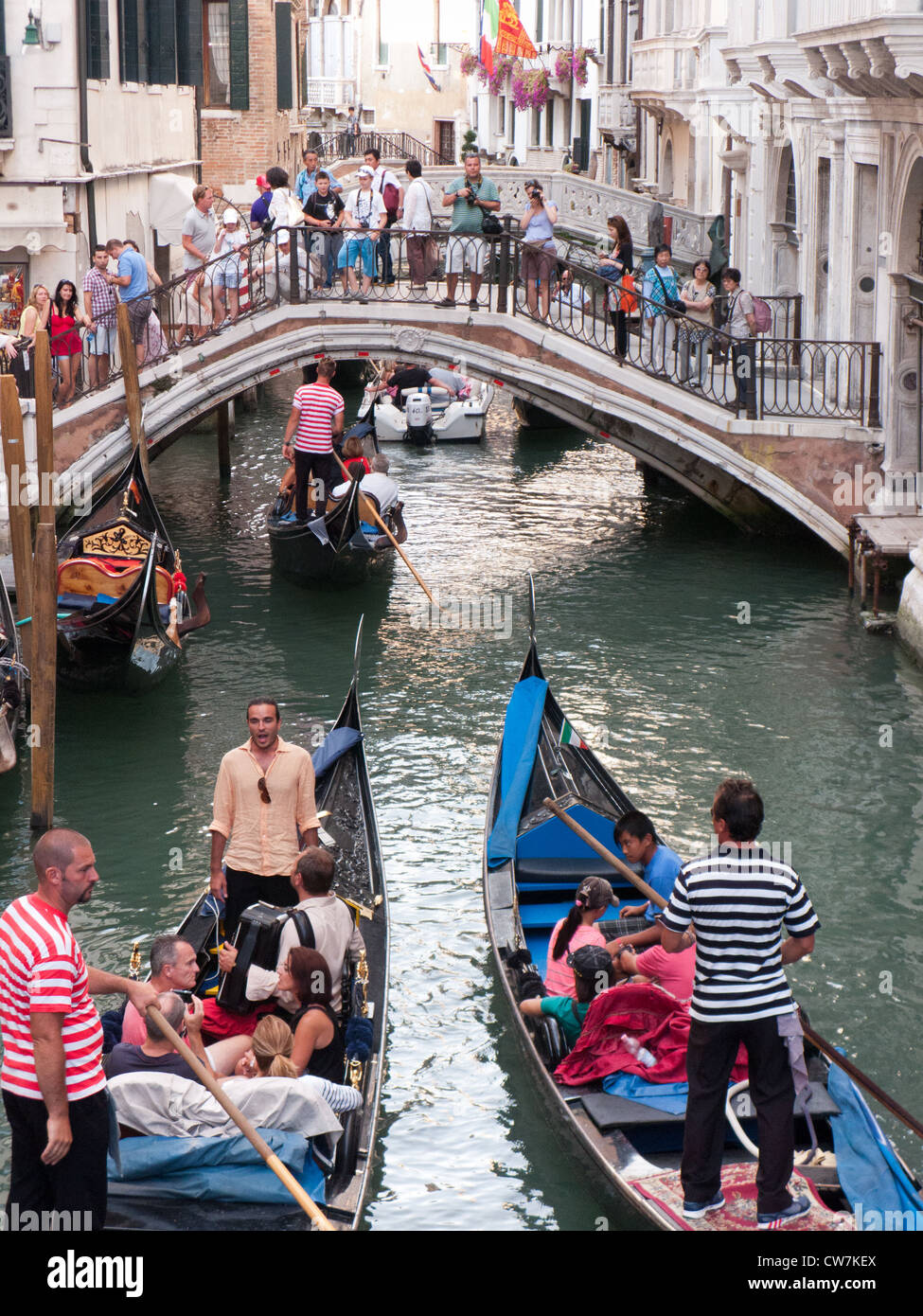 Tourists soak up the atmosphere of the Rio del Palazzo Venice, Italy Stock Photo