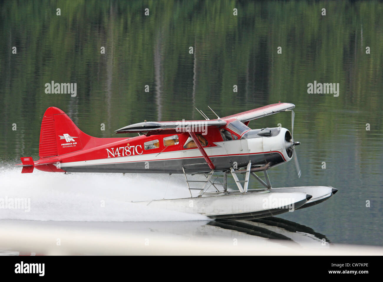 A floatplane filled with mail takes off in Alaska Stock Photo