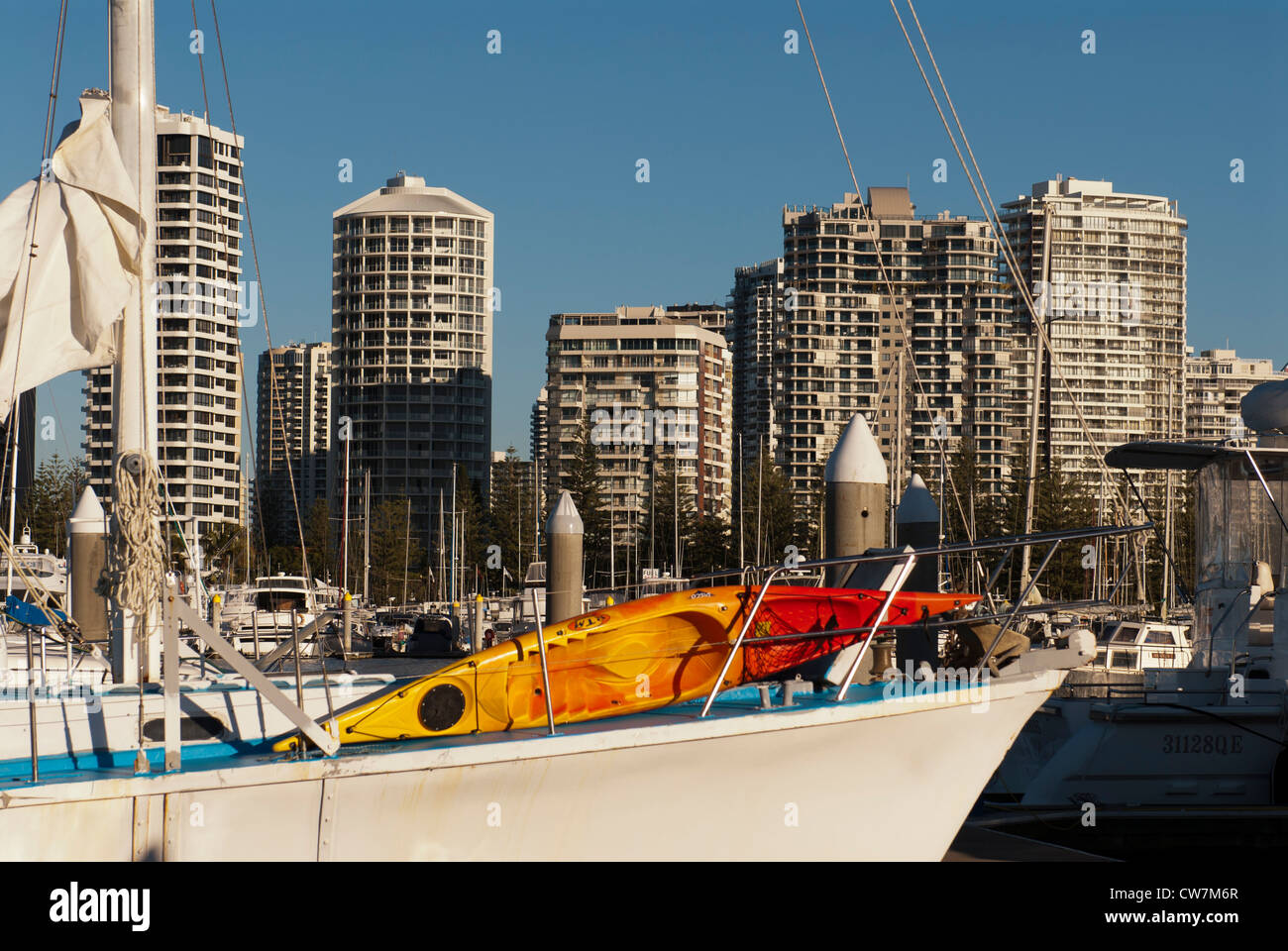 Boats moored at Marina Mirage with the Southport Yacht Club and Main Beach apartment towers in distance. Stock Photo