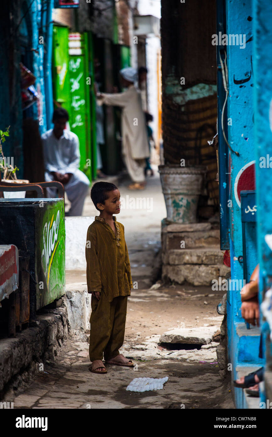 Young boy in a narrow alley in Said Pur Village, Islamabad, Pakistan Stock Photo