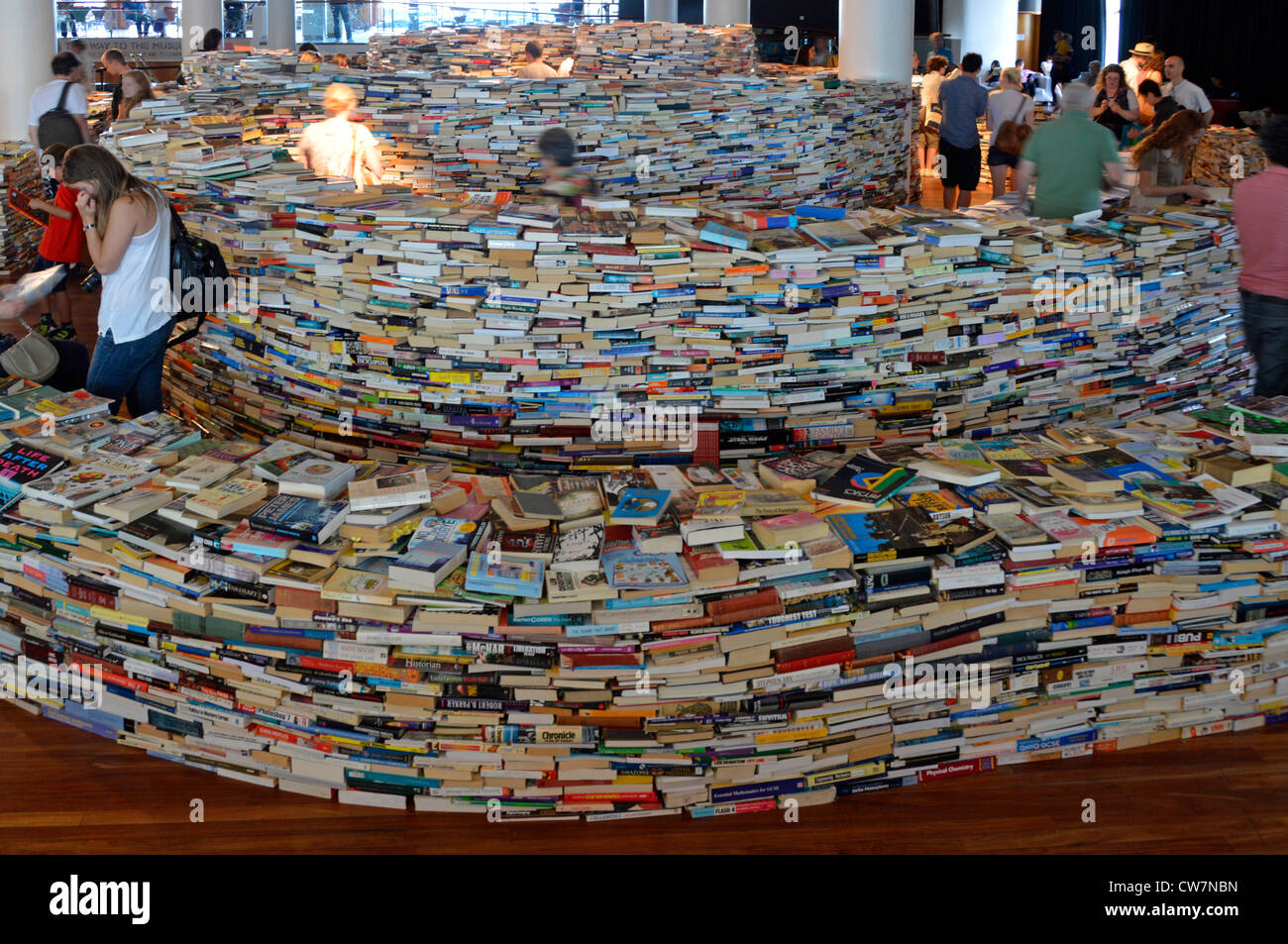 People wandering around indoor maze built with 250,000 books inspired by Jorge Luis Borges & created by Brazilian artists Marcos Saboys & Gualter Pupo Stock Photo