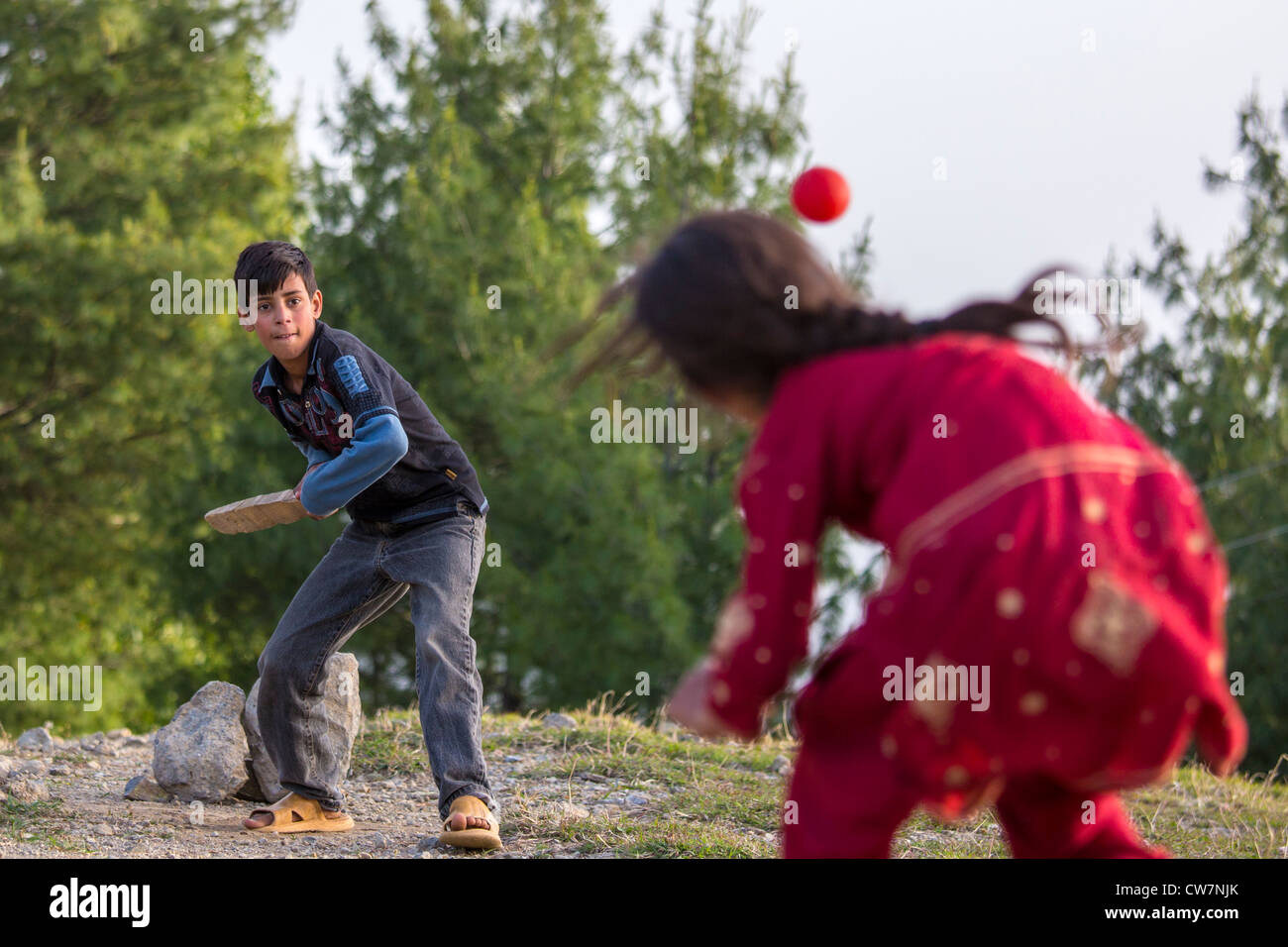 Girl bowling, cricket in Nathia Gali, Hazara, Khyber Pakhtunkhwa, Pakistan Stock Photo