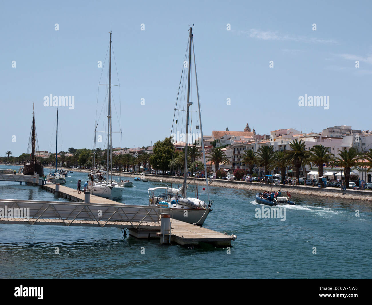 Boats docked on the Ribeira de Bensafrim leading to the marine at Lagos, Portugal. Stock Photo