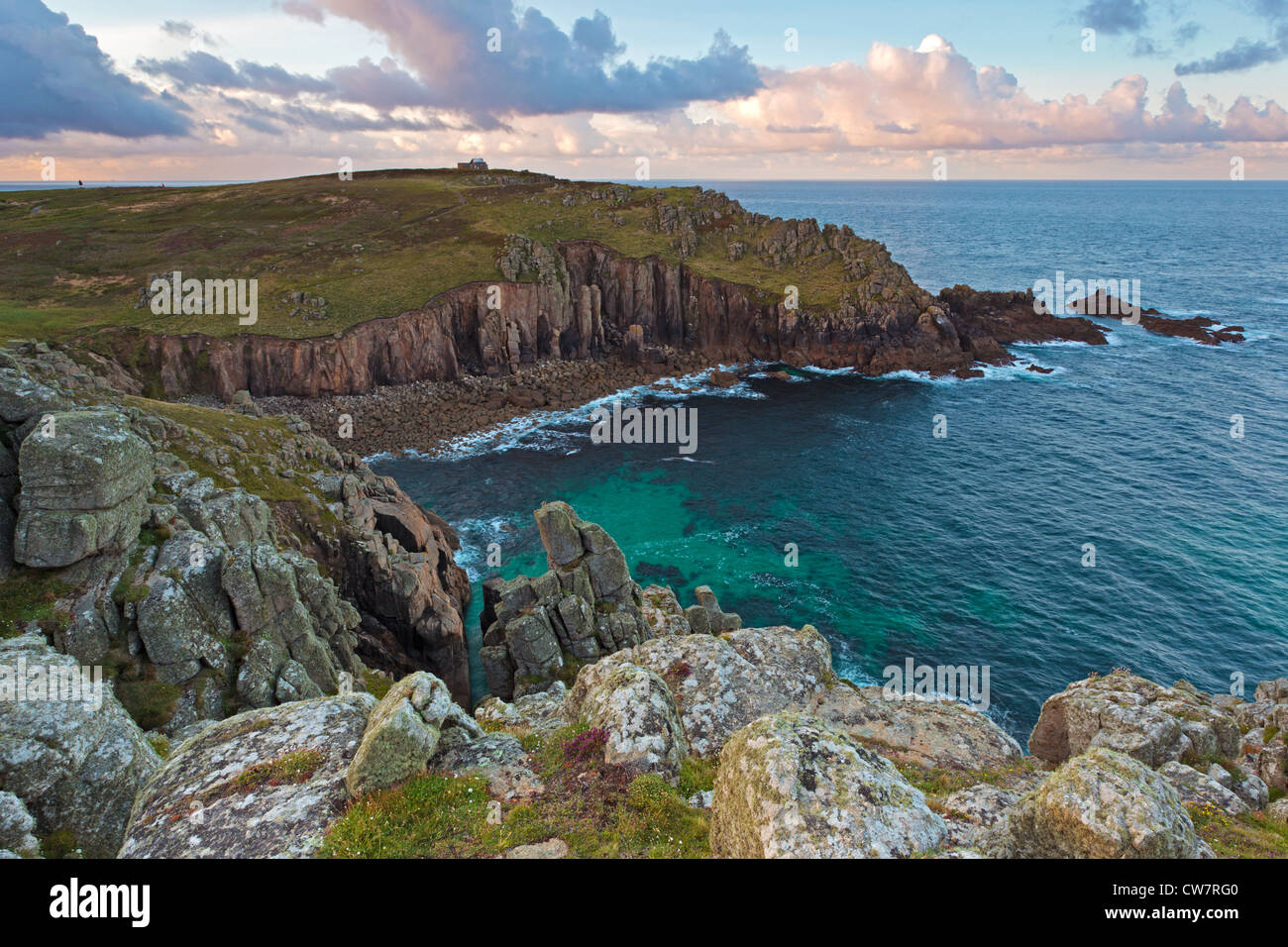 Porth Loe in Cornwall with Gwennap head coastguard station in the distance Stock Photo
