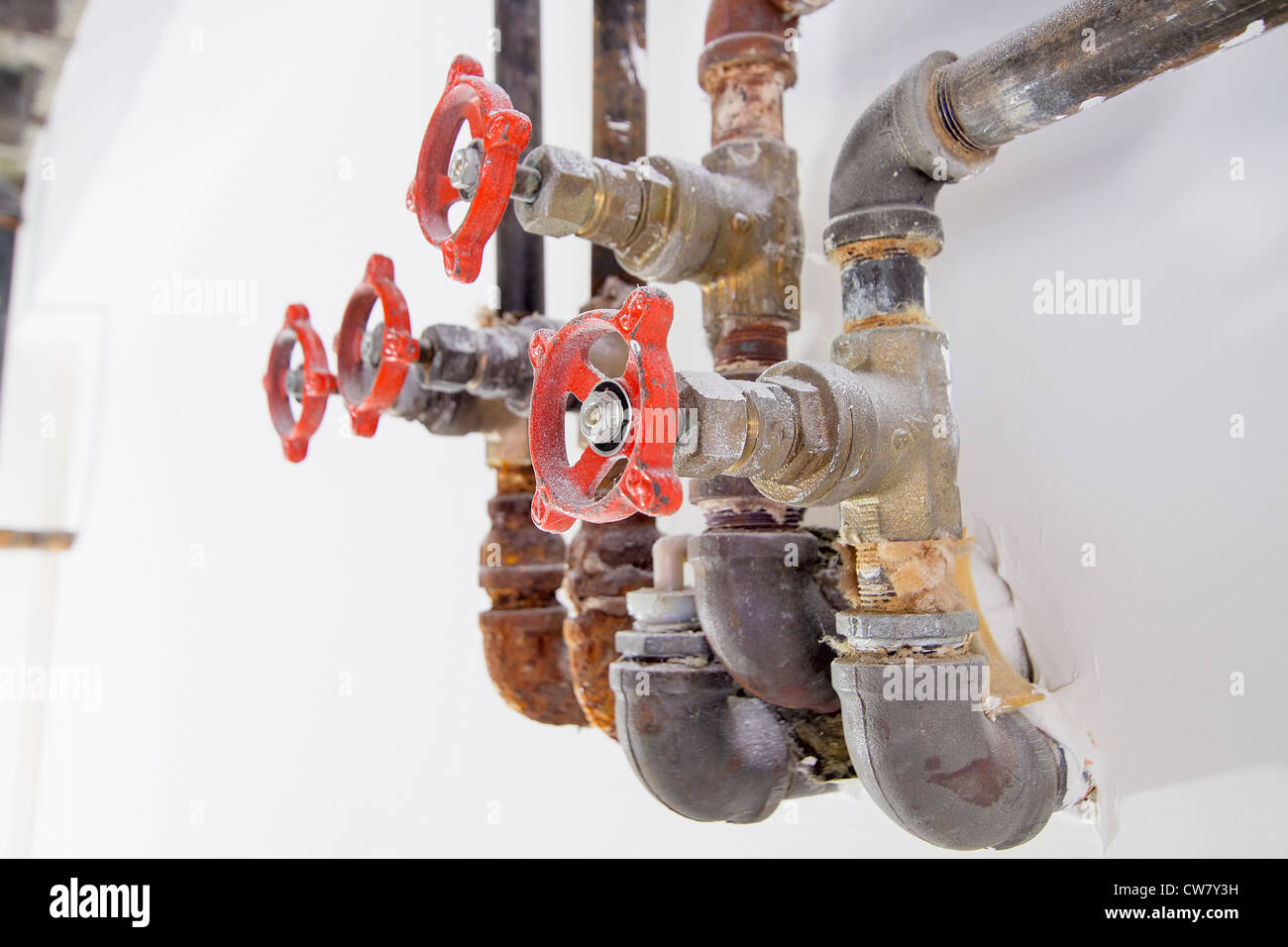 Old Heating Cooling Water Plumbing Pipes with Valves Macro Closeup Stock Photo