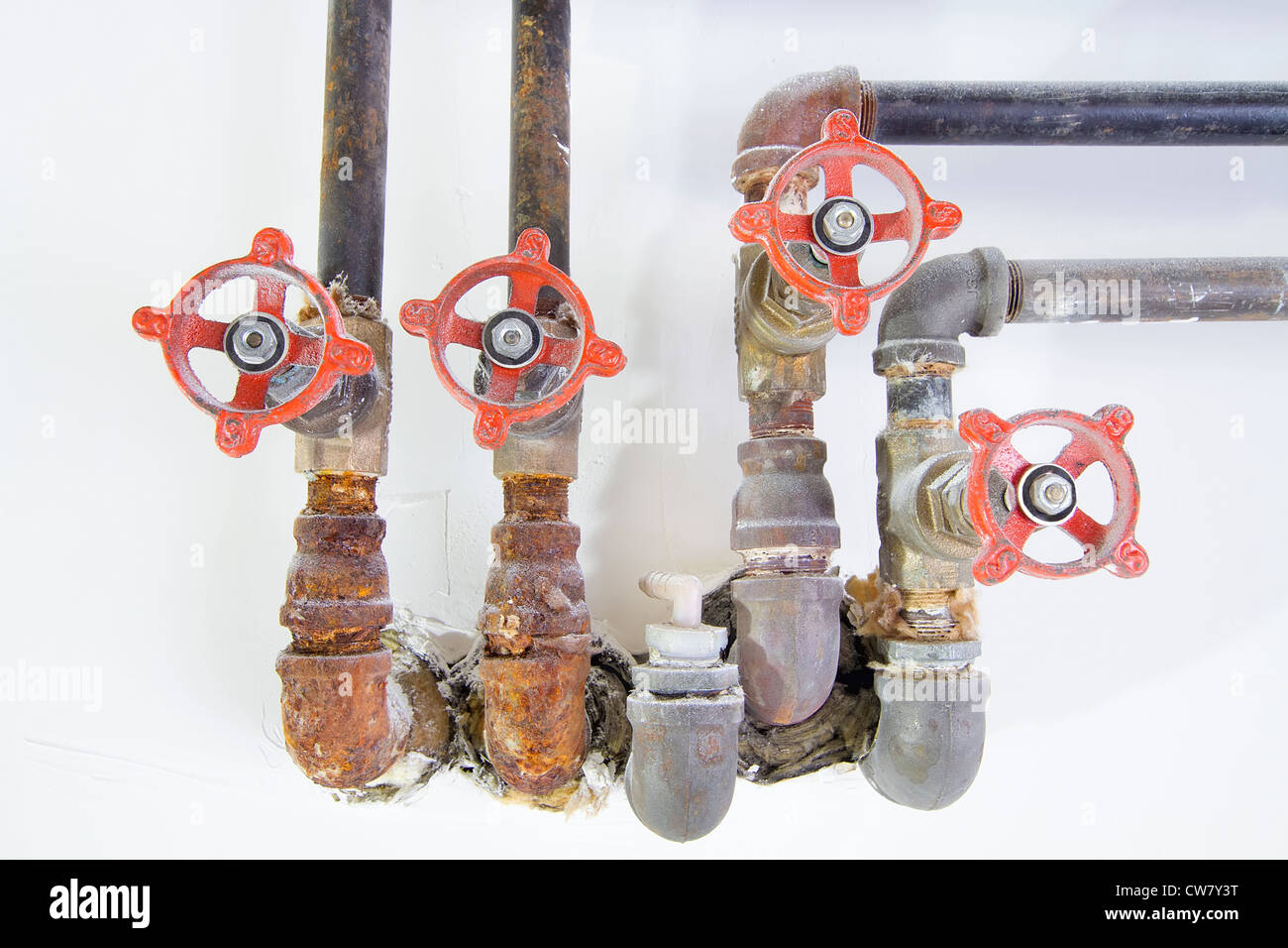 Old Heating Cooling Water Plumbing Pipes with Valves Macro Closeup Front Stock Photo
