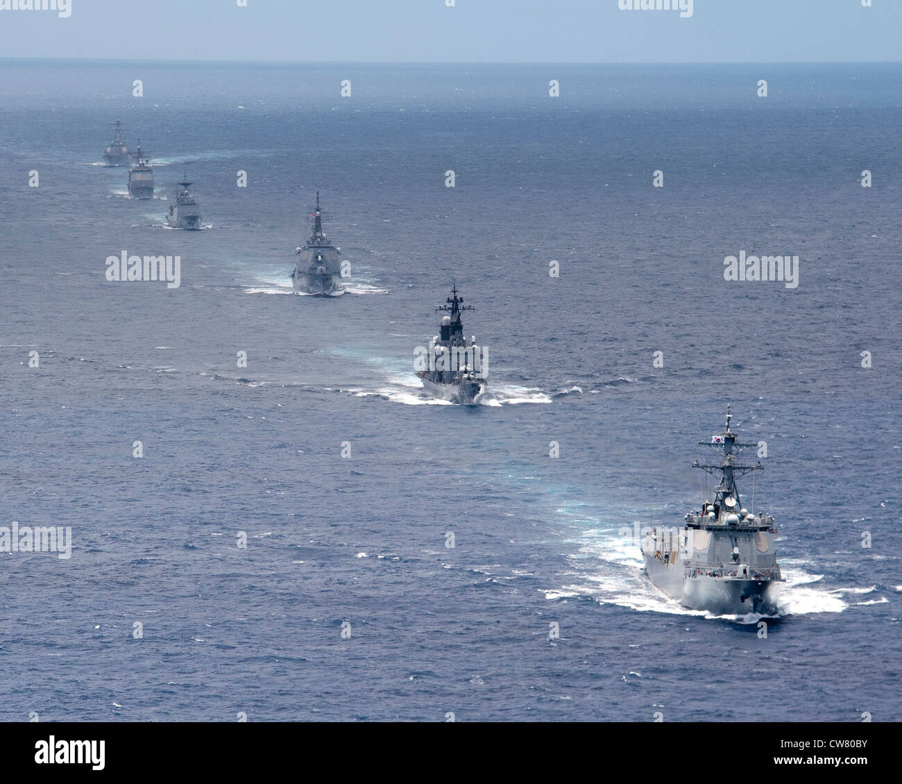 A formation of ships from the U.S. Navy, U.S. Coast Guard, Japan Maritime Self-Defense Force, and the Republic of Korea Navy maneuver in the Pacific Ocean during a trilateral exercise (TRILATEX). TRILATEX is intended to increase interoperability, operational proficiency and readiness between partnering nations. The ships included The guided missile destroyer USS Chafee (DDG 90), the guided missile cruiser USS Port Royal (CG 73), USCGC Galveston Island (WPB 1349), JS Moyoko (DD 175), JS Shirane (DDH 143), ROKS Yulgok Yi I (DDG 992) and ROKS Choi Young (DDH 981). Stock Photo