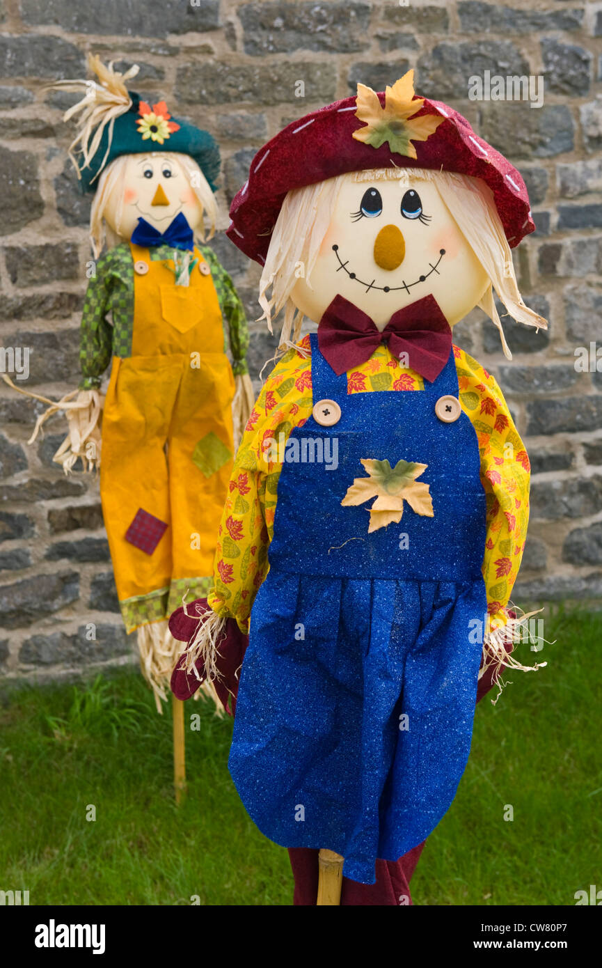 Scarecrows in garden at village fete on Scarecrow Day festival in