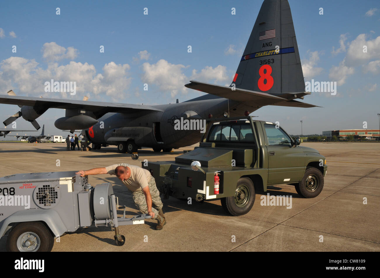 Tech. Sgt. Robert Â€Œwayneâ€ Craft, An Aerospace Ground Equipment (Age)  Craftsman In The 145Th Maintenance Squadron, North Carolina Air National  Guard, Drops Off A Mc20 Air Compressor To C-130 Hercules Cargo Plane,