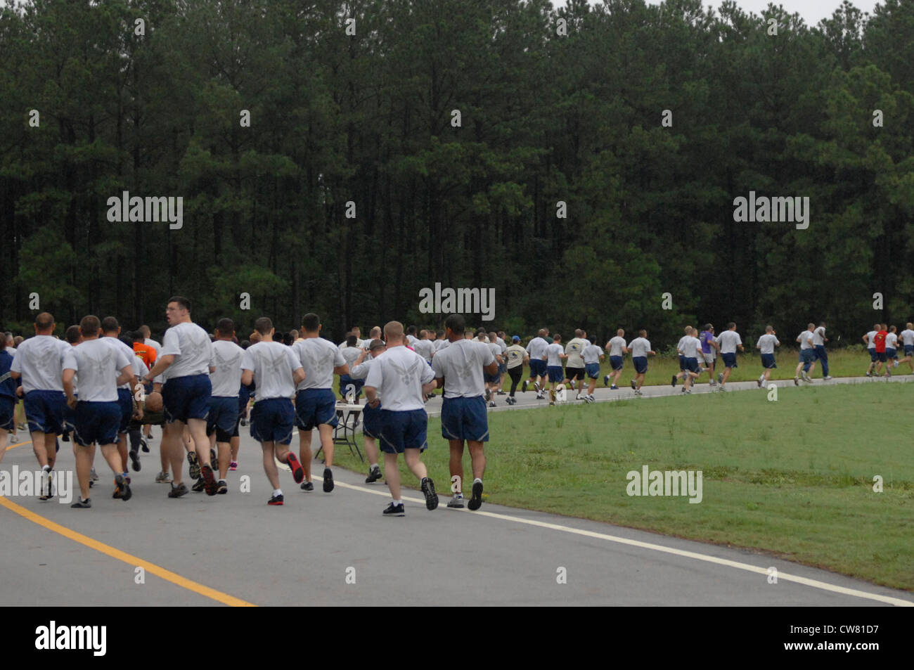 Airmen race through Shaw Air Force Base, S.C., during a 5K Poker Run Aug. 10, 2012. The race began after morning reveille and had participants collect five cards which were then used afterwards to win prizes. Stock Photo