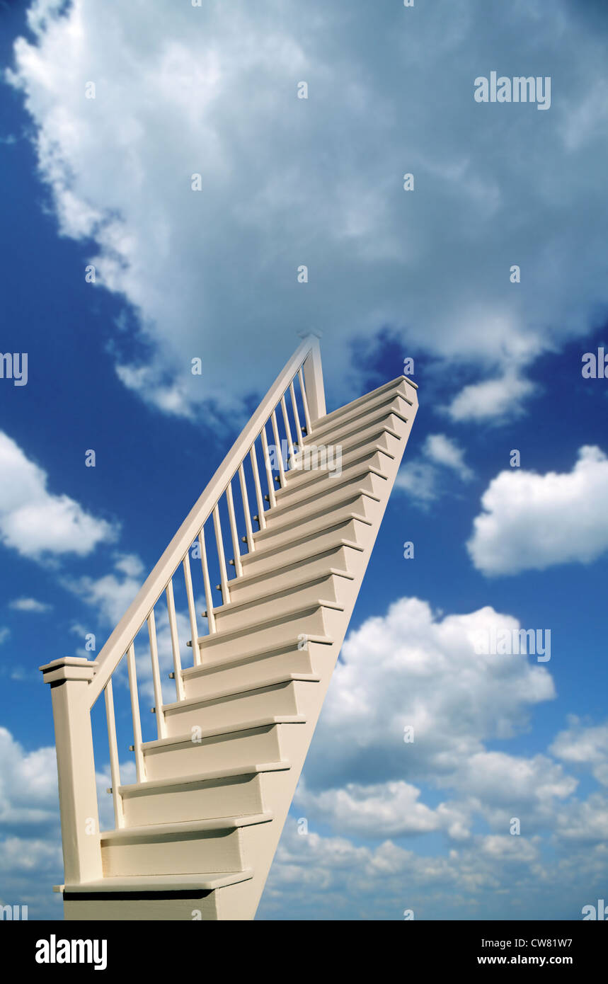 Stairs leading up to a blue sky with puffy white clouds Stock Photo