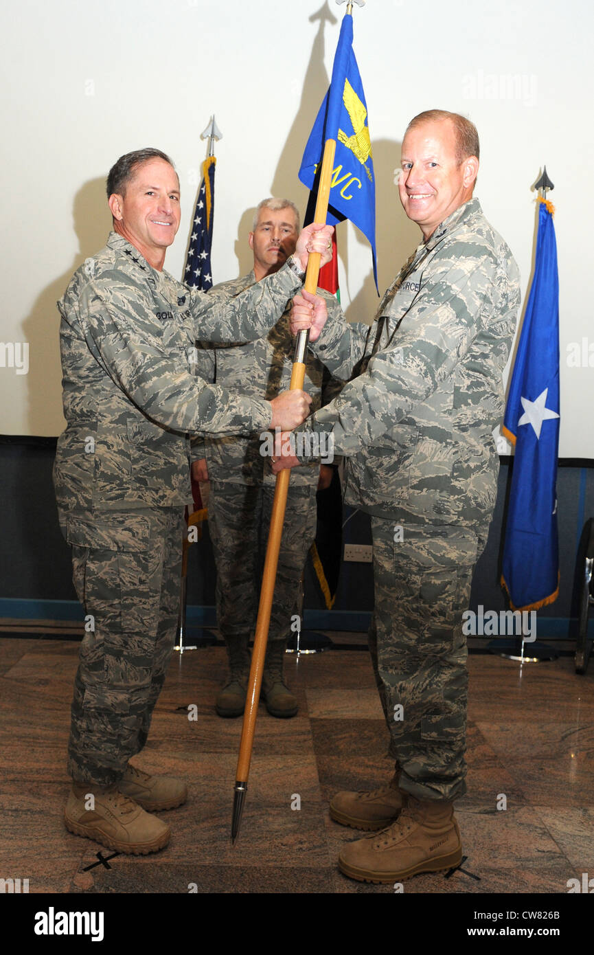 SOUTHWEST ASIA - U.S. Air Force Lt. Gen. David Goldfein, U.S. Air Forces Central Command and Combined Forces Air Component Commander, passes the AFCENT Air Warfare Center's guidon to Col. Daniel Tippet during a change of command ceremony Aug. 15, 2012. Tippet replaced Col. Robert Swaringen as AFCENT's AWC commander. Stock Photo