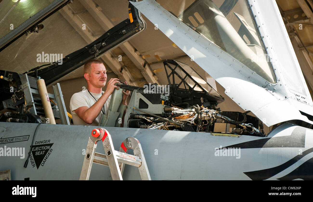 TSgt Robert Haag, an aircraft phase maintenance specialist with the 455th Expeditionary Maintenance Squadron, works in the cockpit of a U.S. Air Force A-10 Thunderbolt II during phase maintenance at Bagram Airfield, Afghanistan, August 9, 2012. The Airmen adhere to a strict schedule of maintenance to keep Bagram’s aircraft safe and operational. Stock Photo