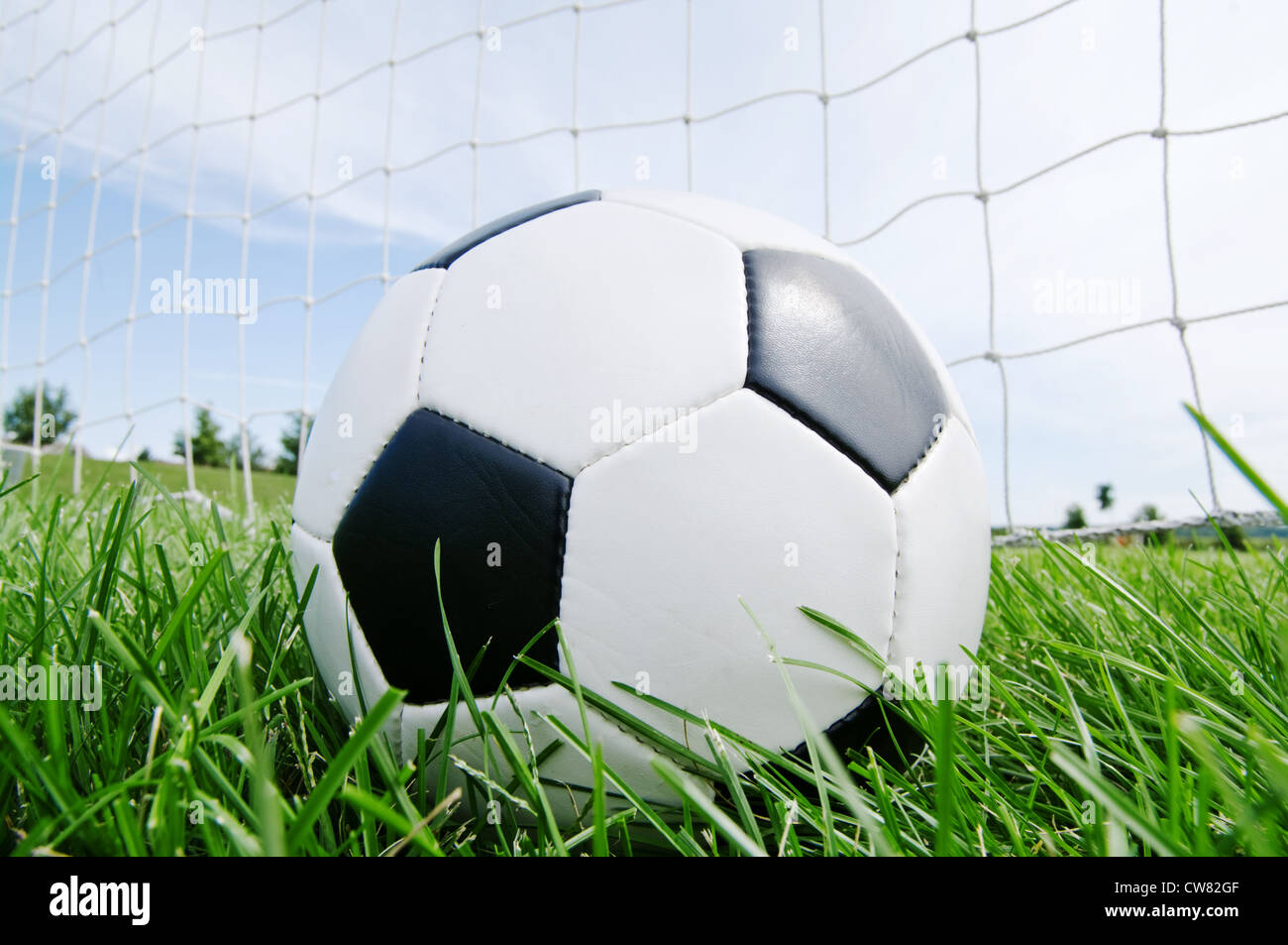 Classic football in the goal net Stock Photo