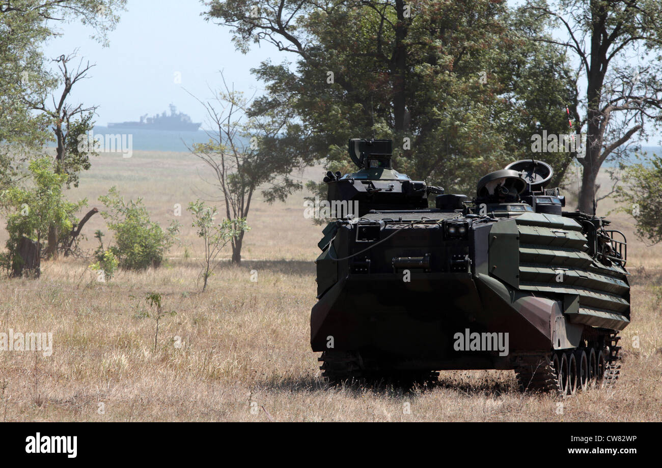 A U.S. Marine Corps amphibious assault vehicle with Security Cooperation Task Force Africa Partnership Station 2012 holds its position while partnering with Romanian Marines from the 307th Naval Infantry Battalion during a beach assault in Capu Midia, Romania, Aug. 12, 2012. The beach assault was the final event of Exercise Summer Storm 12. Stock Photo