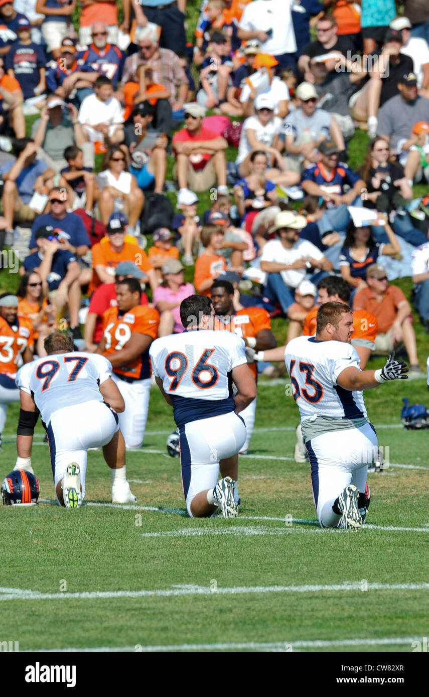 Benjamin Garland, 63, Denver Broncos defensive end, stretches during