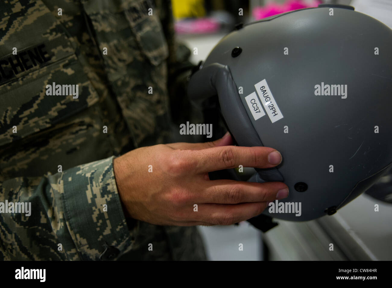 Staff Sgt. Philip DuChene, 437th Operations Support Squadron aircrew flight equipment technician, displays an expiration date for a helmet inspection Aug. 6, 2012, at Joint Base Charleston - Air Base, S.C. Members of AFE are essential to aircrews by making sure all flight equipment is in working order, including emergency safety equipment such as parachutes and survival equipment. Stock Photo
