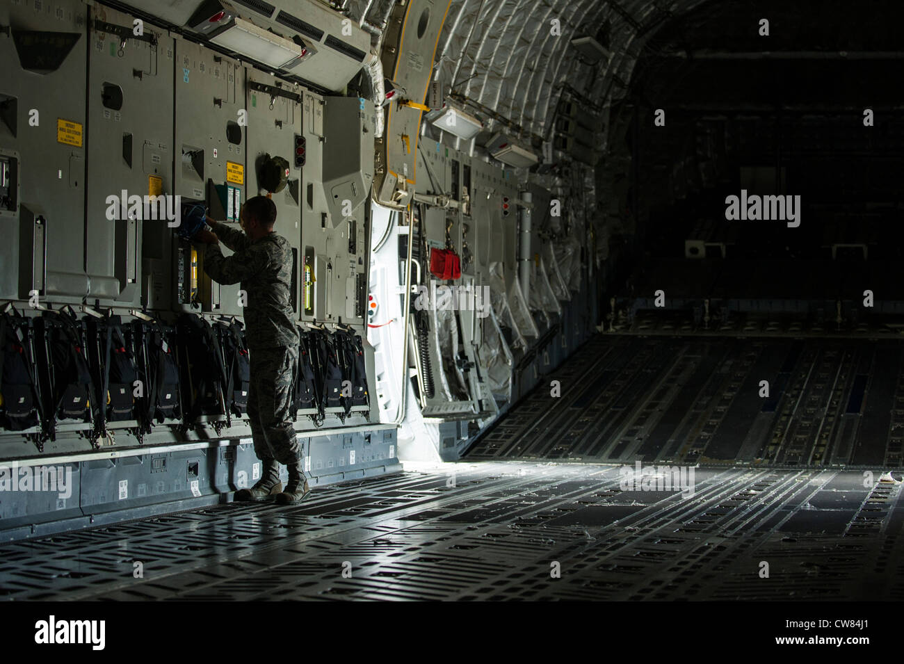 Staff Sgt. Philip DuChene, 437th Operations Support Squadron aircrew flight equipment technician, swaps out a Quick Don Mask on a C-17 Globemaster III during a post-flight equipment swap-out Aug. 6, 2012, at Joint Base Charleston - Air Base, S.C. Members of AFE are essential to aircrews by making sure all flight equipment is in working order including emergency safety equipment, such as parachutes and survival equipment. Stock Photo