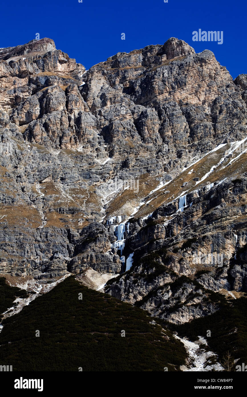 Cliff faces and frozen waterfalls above The Edelweisstal above Colfosco winter  between Selva and Corvara Dolomites Italy Stock Photo