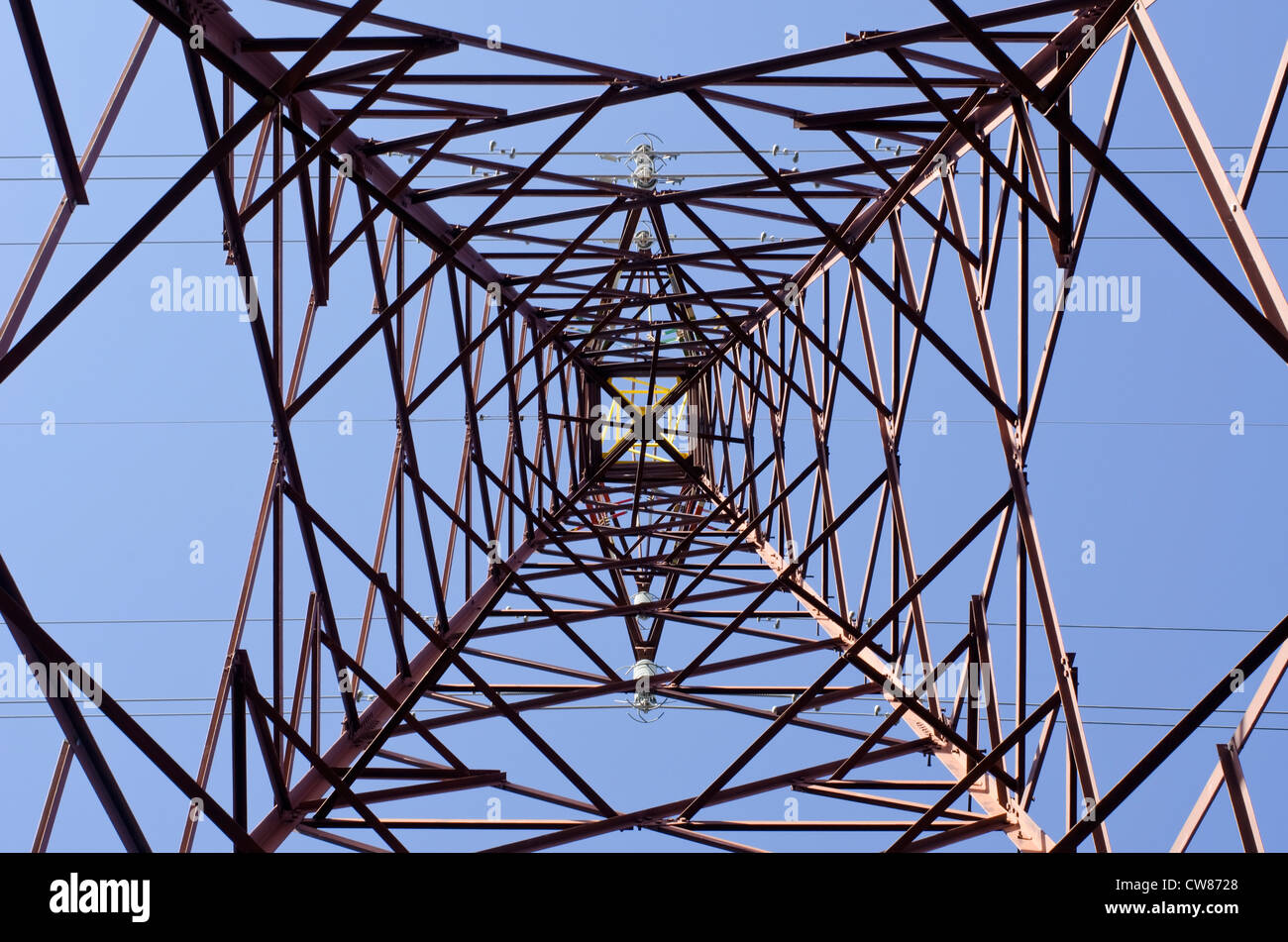 Transmission tower as seen from below towards a blue sky Stock Photo
