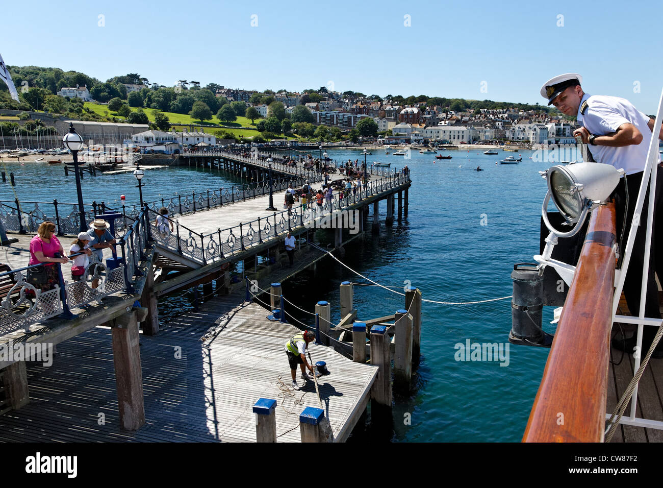 The Captain of the MV Balmoral brings the historic boat alongside Swanage Pier. Stock Photo
