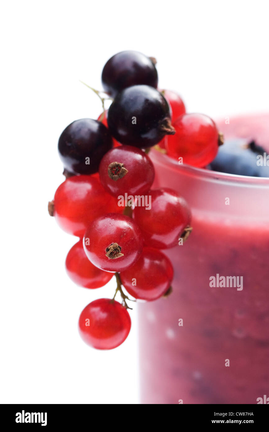 Summer berry smoothie and fruits against a white background. Stock Photo