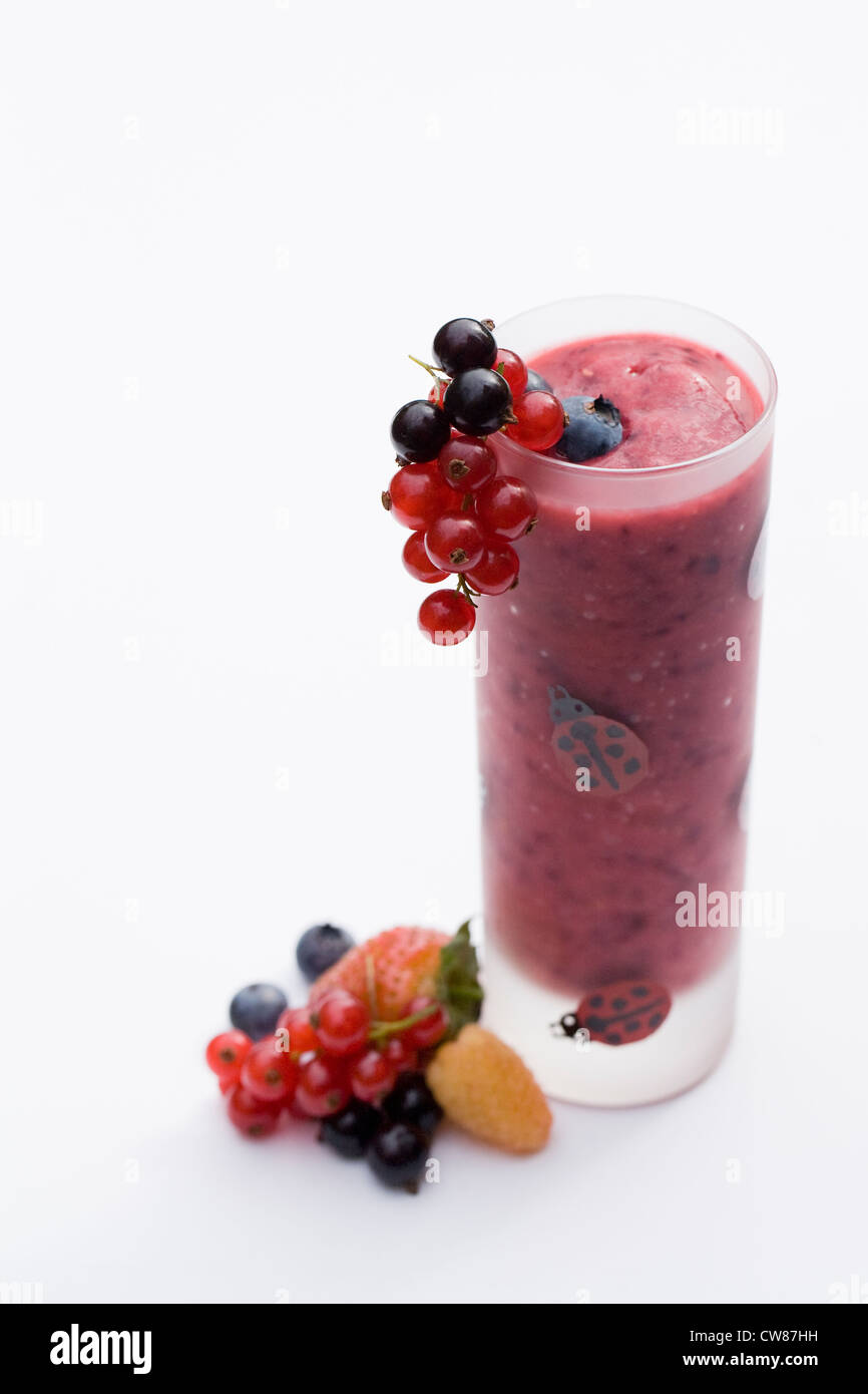 Summer berry smoothie and fruits against a white background. Stock Photo