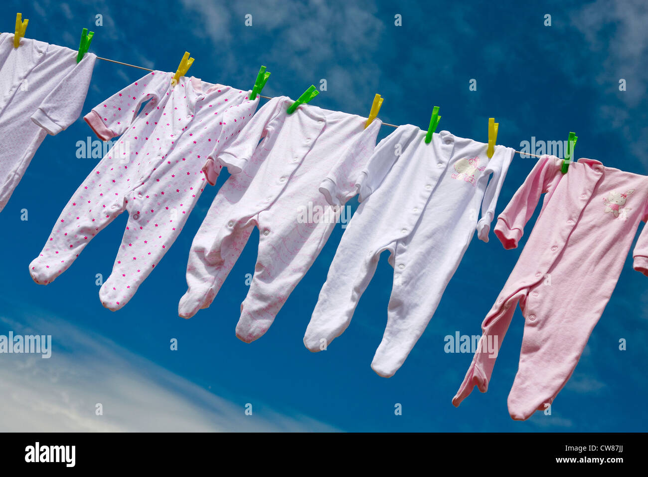 Baby grows hanging on a washing line Stock Photo