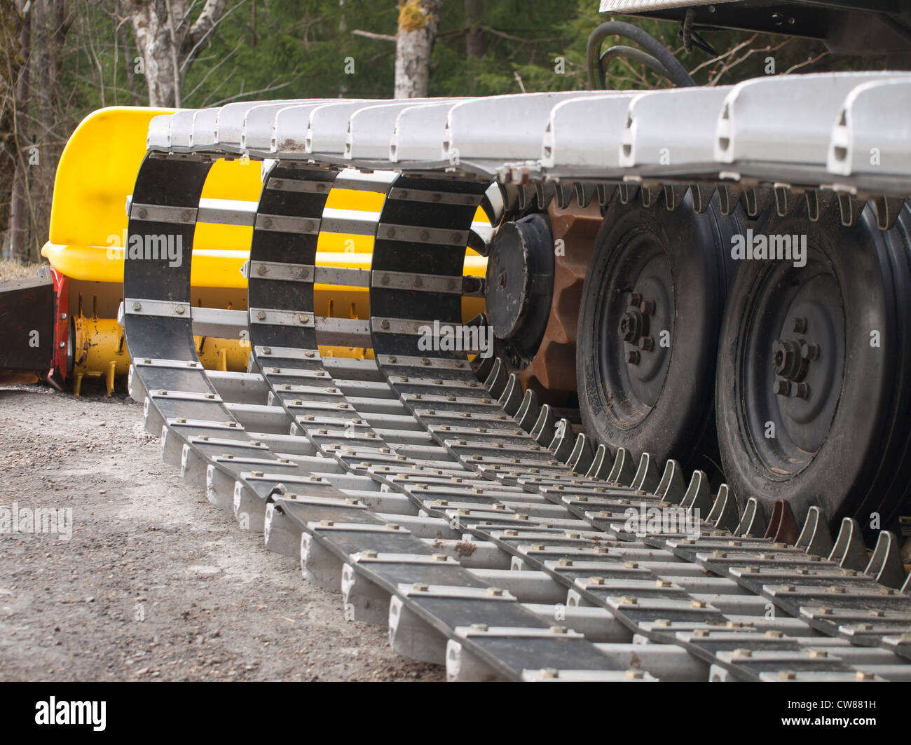 Continuous tracks or caterpillar tracks of an all terrain vehicle used for preparing ski tracks and a ski jump hill Stock Photo