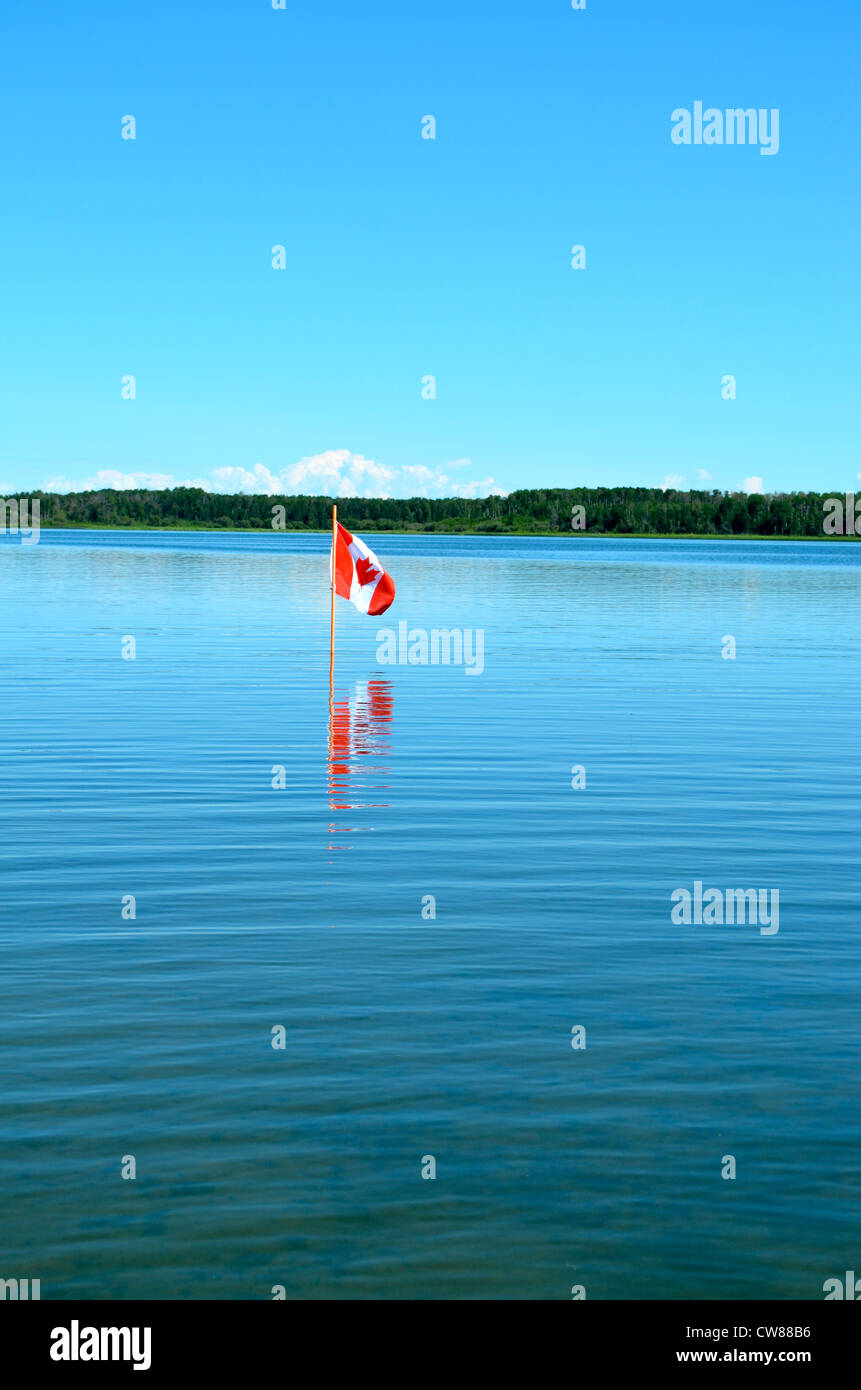 Canadian flag reflected in the lake. Stock Photo