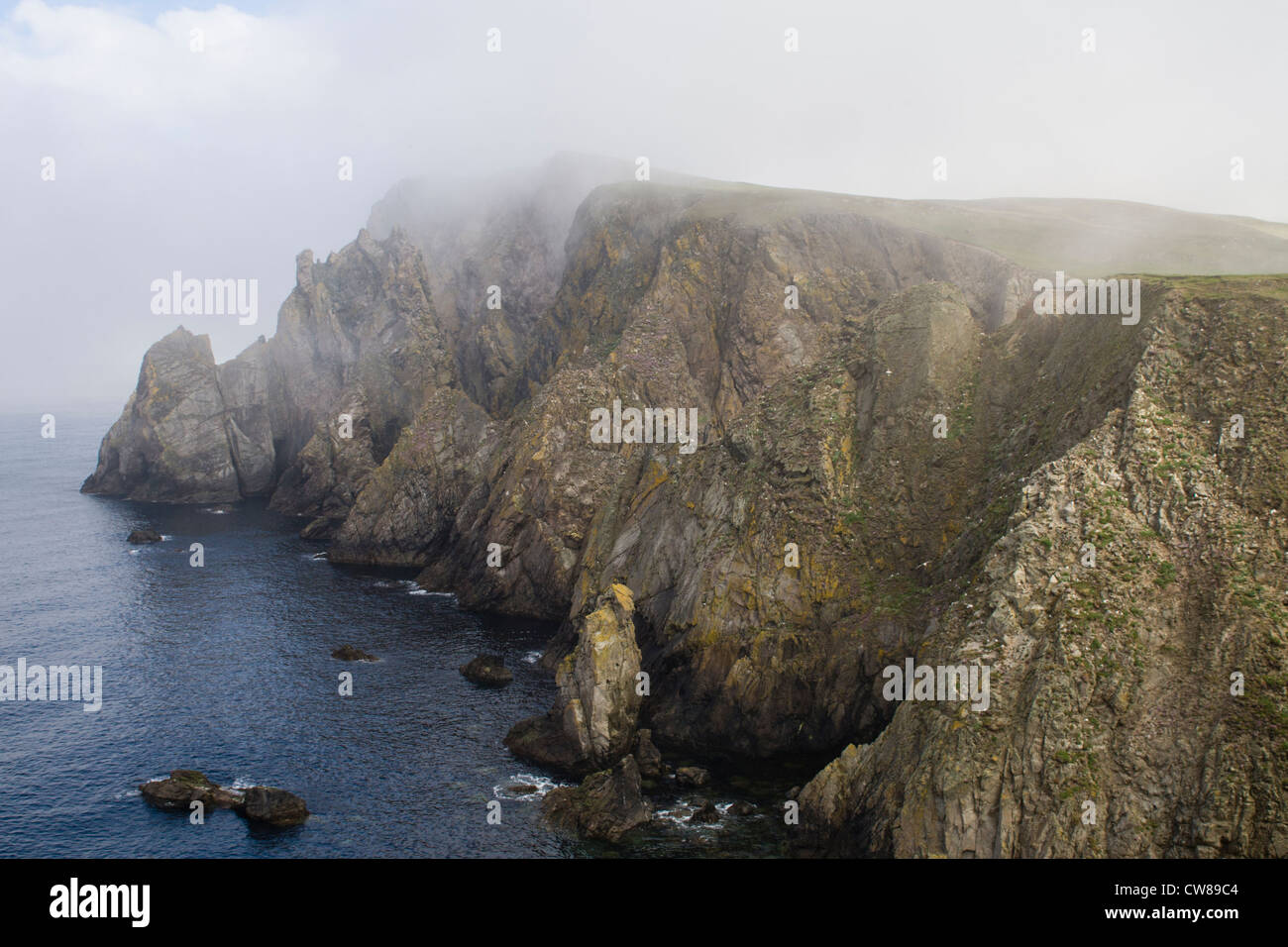 Cliffs and sea mist on Fair Isle, Shetland Stock Photo