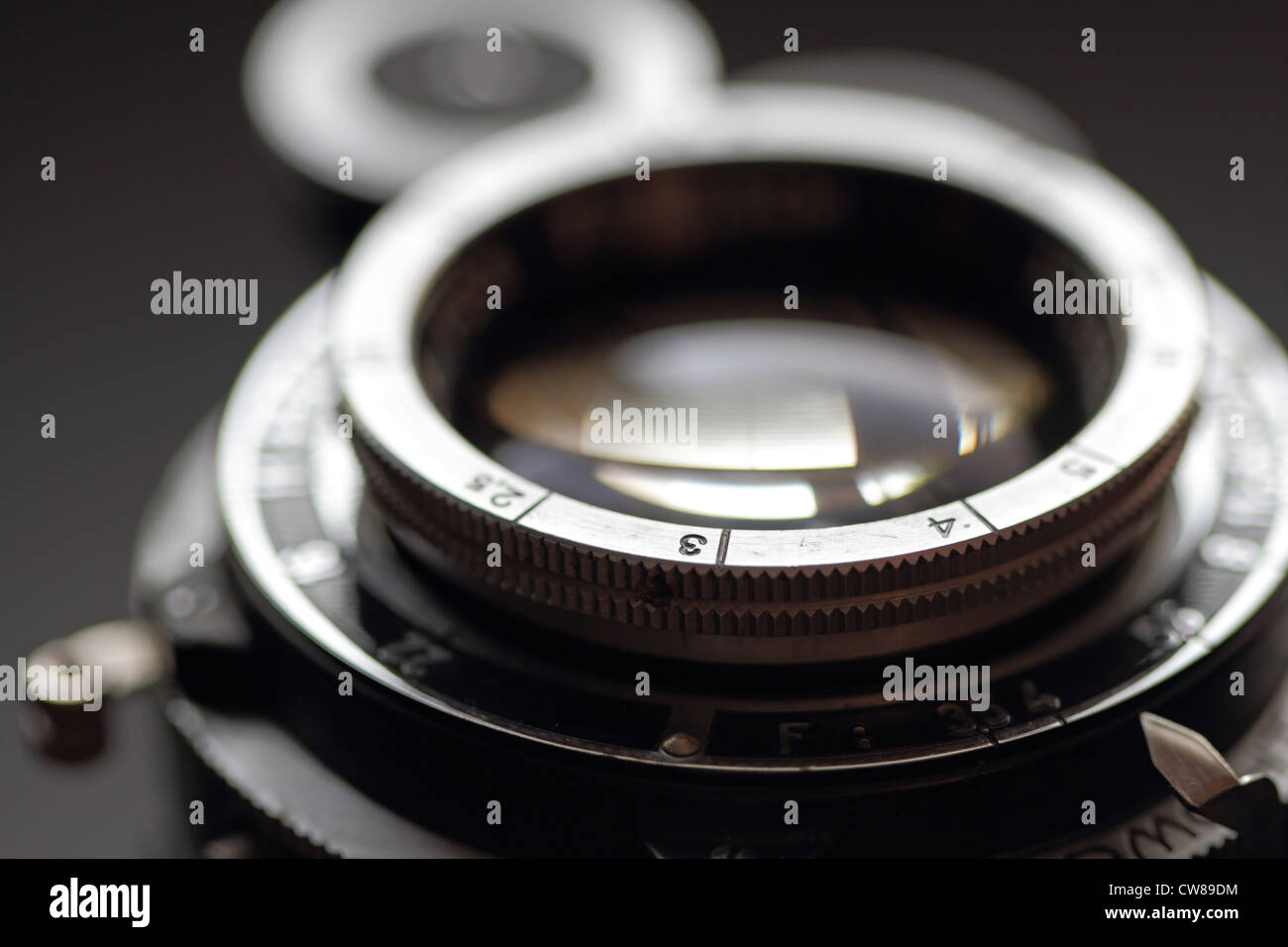 An old photographic lens close-up. hallow DOF. Stock Photo