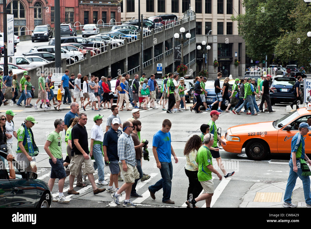 Seattle Sounders soccer fans crowd intersections in Pioneer Square district after watching team defeat Vancouver White Caps Stock Photo