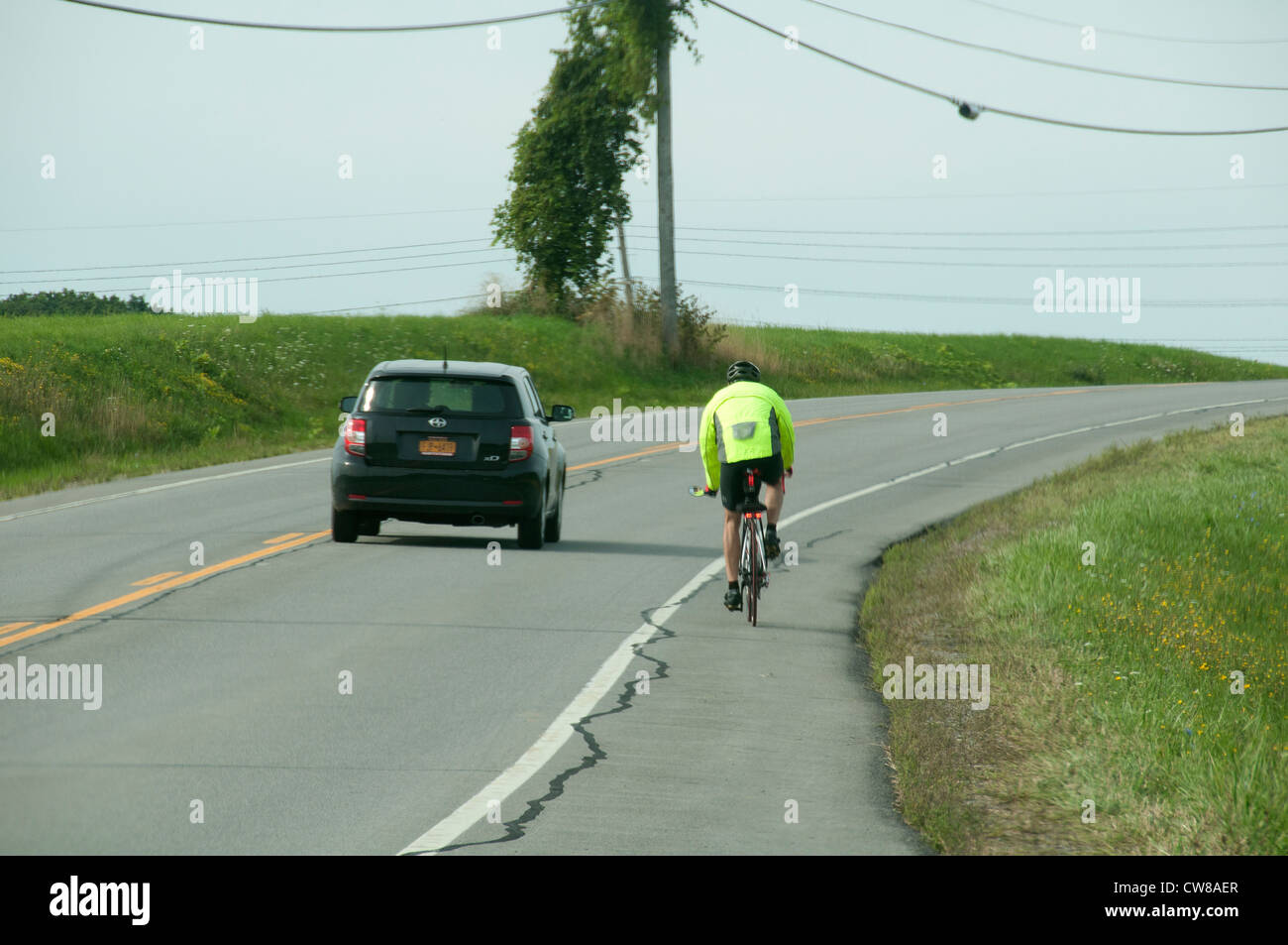 Biker and car sharing road Stock Photo Alamy