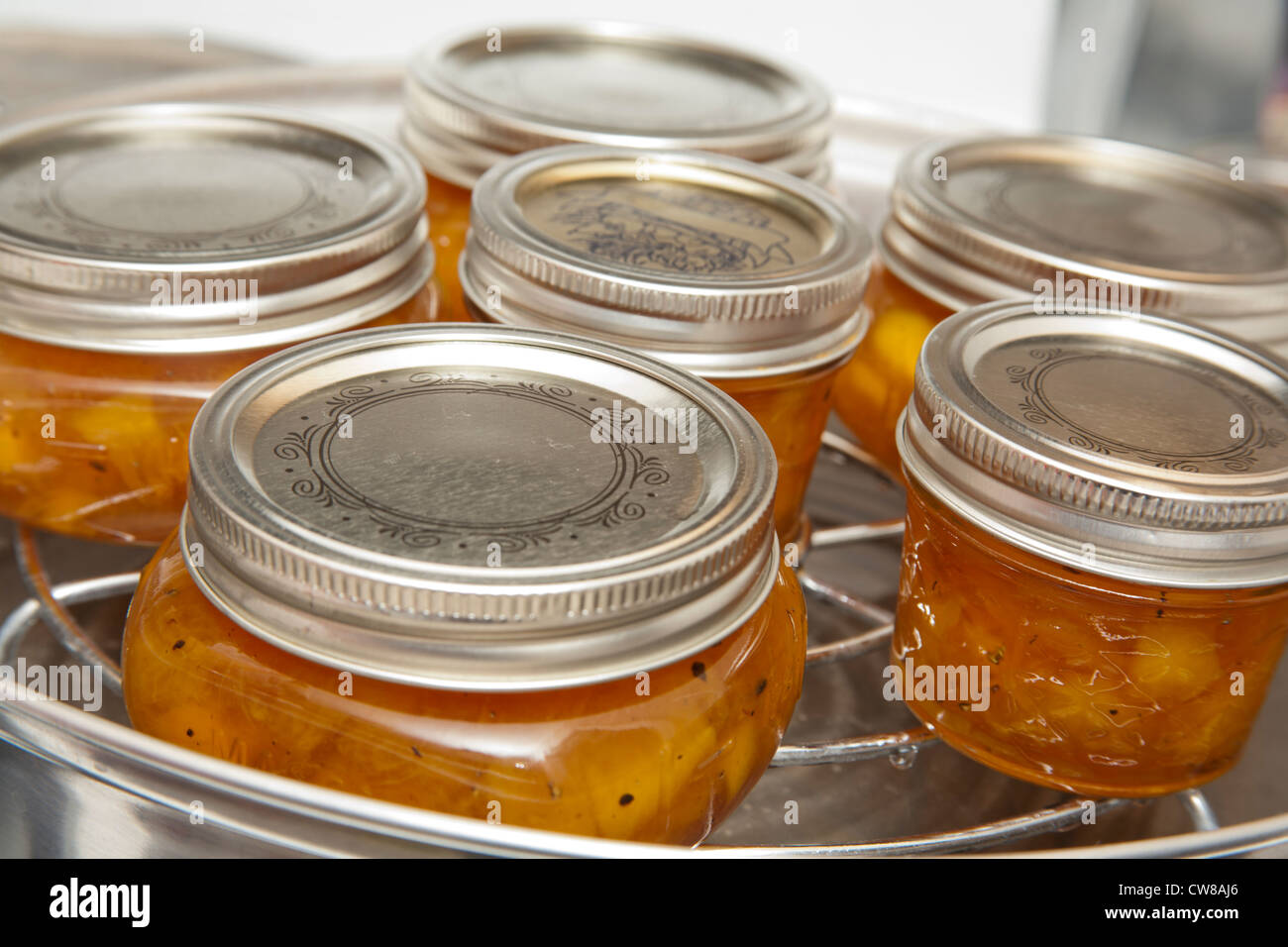 Jars of home canned preserves being processed Stock Photo