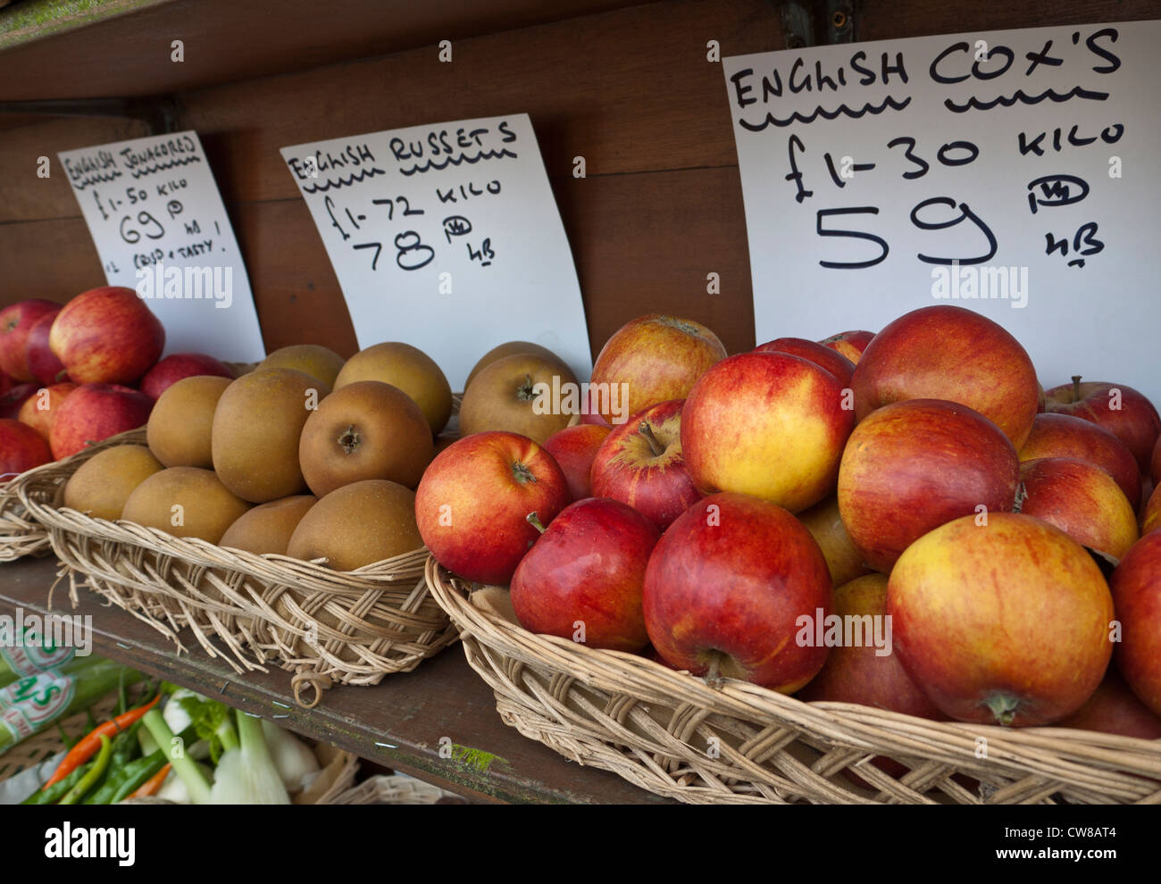 Village greengrocer display of local English apples including  baskets of Cox's and Russets varieties Stock Photo