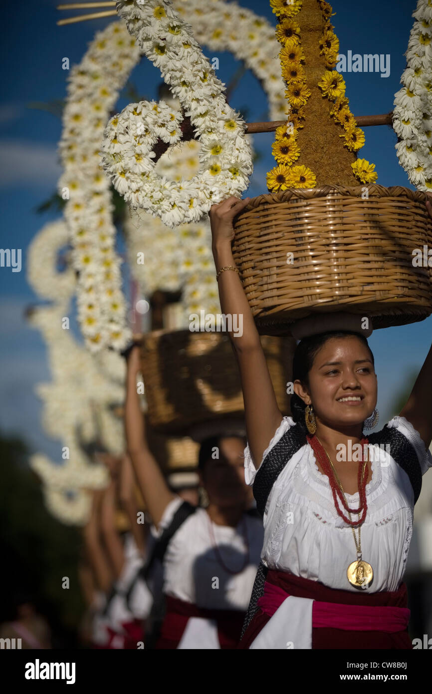 'Chinas oaxaquenas' carry baskets with flowers in their heads in Oaxaca, Mexico, July 21, 2012. Stock Photo